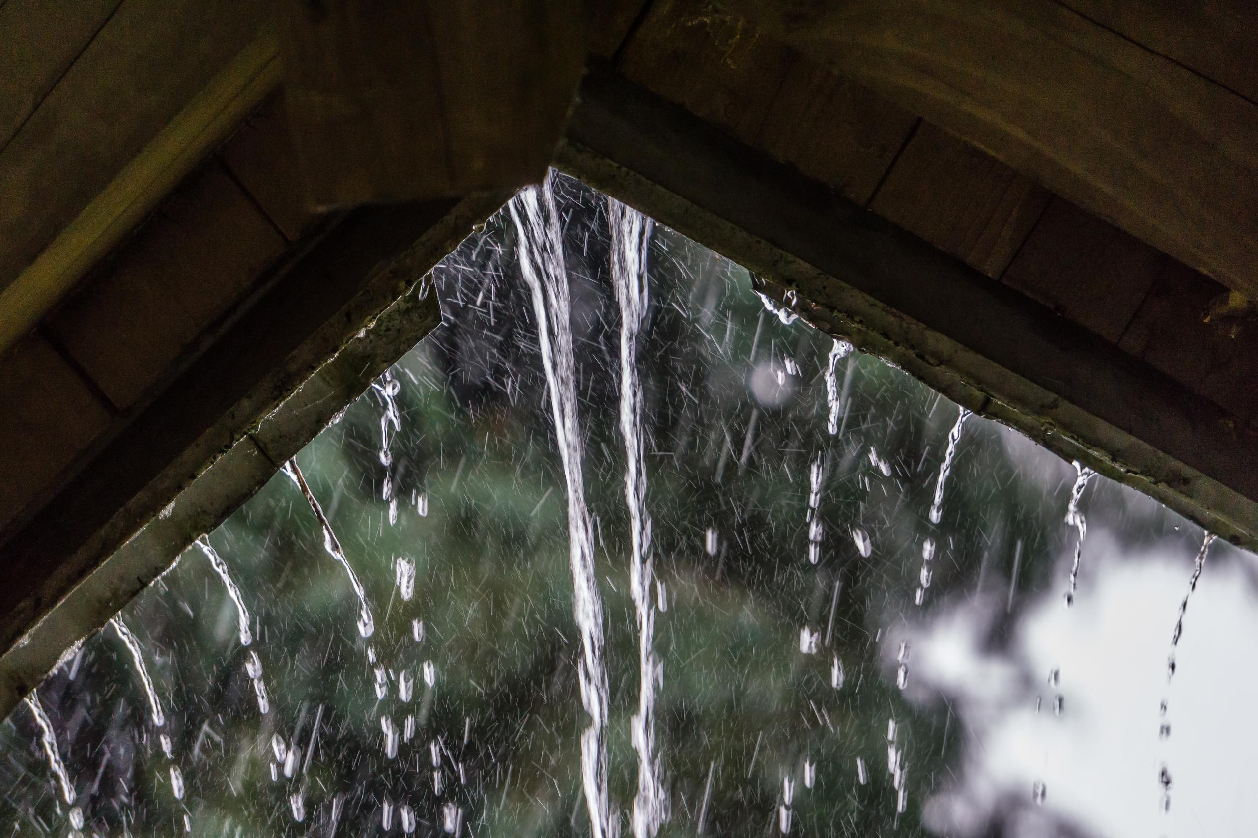raindrops stream off of a roof in renton washingt 2026 04 14 00 12 38 utc